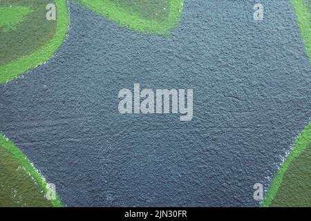 Fragment of the wall with colorful graffiti painting in the street. Part of colorful street art yellow color graffiti on gray painted wall background Stock Photo