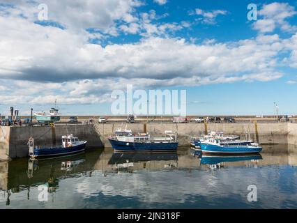 Boats moored in North Sunderland harbour, Seahouses, Northumberland, England, UK Stock Photo