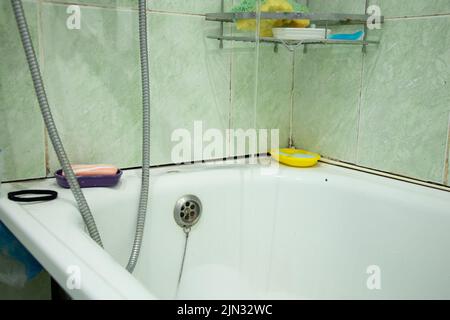 an old bathroom in a Soviet apartment without renovation, a bathroom with old renovations, a bathroom Stock Photo