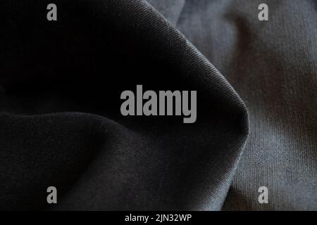 Gray black wrinkled velor fabric as background closeup, fashion and trends, gray background Stock Photo