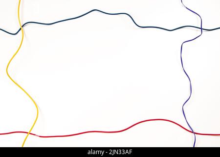 Colorful electrical cord wires cables on white background. Top view, copy space Stock Photo