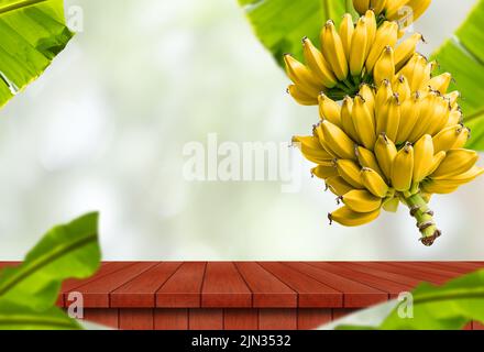 A ripe yellow bananas with empty wooden table on bokeh background Stock Photo