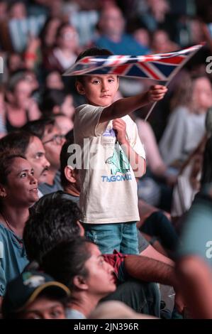 Victoria Square, Birmingham, England, August 8th 2022. - A boy waves a union flag as thousands of spectators crammed in to Victoria Square in Birmingham to watch the closing ceremony of the 2022 Commonwealth Games. Pic by Credit: Stop Press Media/Alamy Live Newsr Stock Photo