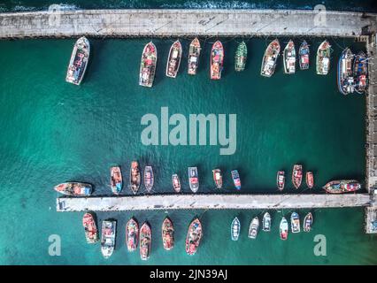 A aerial drone shot of many fishing boats in Kalk Bay harbour, near Cape Town, South Africa Stock Photo