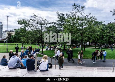 Crowds in Eyre Square in Galway, Ireland on a Saturday afternoon, enjoying the August sun. Stock Photo