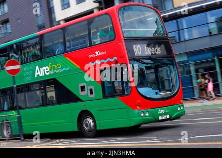 A panning shot of a moving double decker bus in Leeds City Centre  operated by The Keighley Bus Company. Stock Photo