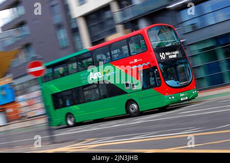 A panning shot of a moving double decker bus in Leeds City Centre  operated by The Keighley Bus Company. Stock Photo