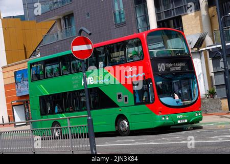 A panning shot of a moving double decker bus in Leeds City Centre  operated by The Keighley Bus Company. Stock Photo