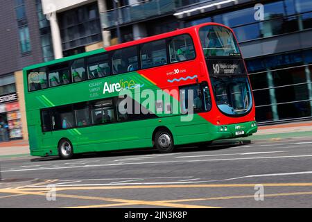 A panning shot of a moving double decker bus in Leeds City Centre  operated by The Keighley Bus Company. Stock Photo