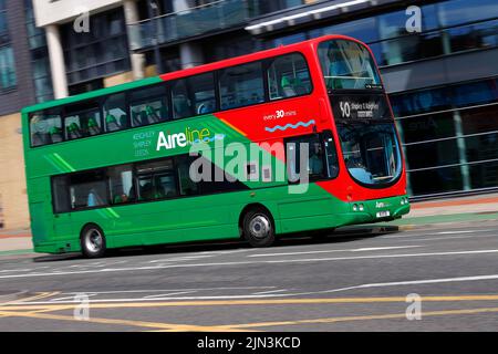 A panning shot of a moving double decker bus in Leeds City Centre  operated by The Keighley Bus Company. Stock Photo