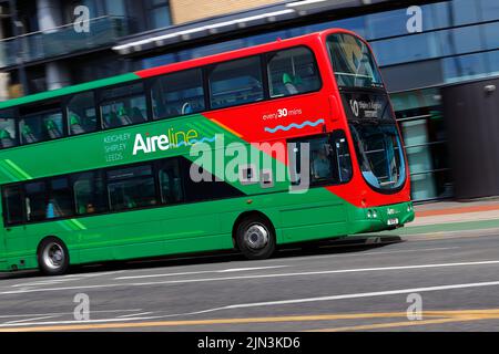 A panning shot of a moving double decker bus in Leeds City Centre  operated by The Keighley Bus Company. Stock Photo