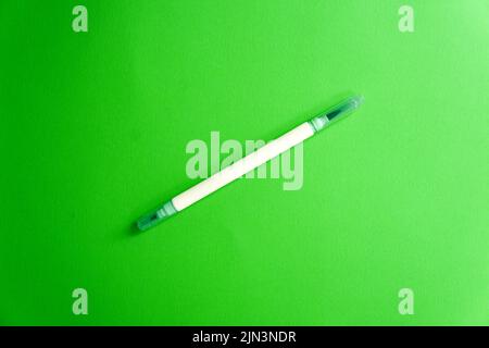 Emerald green marker on a green background, a fresh mood. Back to school. Double sided art marker. Color mood Stock Photo