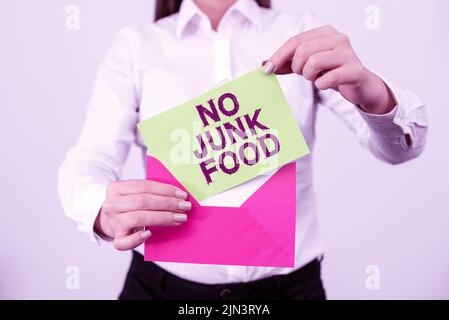 Sign displaying No Junk Food. Word for Stop eating unhealthy things go on a diet give up burgers fries Professional Holding Letter And Envelope Stock Photo