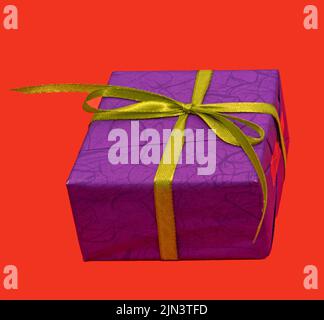 Purple gift box with green ribbon isolated on red background Stock Photo