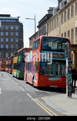 EDINBURGH, SCOTLAND - 1 AUGUST 2022: buses queue in St Andrew Square waiting for passengers for their guided tours of the city Stock Photo