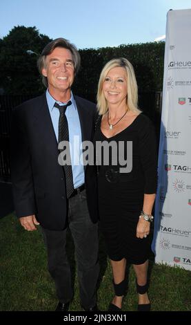 MIAMI BEACH, FL - AUGUST 19: Olivia Newton-John and husband John Easterling at the Tag Heuer watch event. Olivia Newton-John (born 26 September 1948) is an English-born, Australian-raised singer and actress. She is a four-time Grammy award winner who has amassed five No. 1 and ten other Top Ten Billboard Hot 100 singles and two No. 1 Billboard 200 solo albums. She has sold over 100 millions records worldwide making her one of the most successful female recording artists of all time. on August 19, 2010 in New York City. People: Olivia Newton-John John Easterling Stock Photo