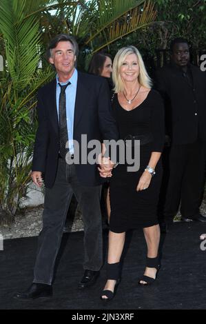 MIAMI BEACH, FL - AUGUST 19: Olivia Newton-John and husband John Easterling at the Tag Heuer watch event. Olivia Newton-John (born 26 September 1948) is an English-born, Australian-raised singer and actress. She is a four-time Grammy award winner who has amassed five No. 1 and ten other Top Ten Billboard Hot 100 singles and two No. 1 Billboard 200 solo albums. She has sold over 100 millions records worldwide making her one of the most successful female recording artists of all time. on August 19, 2010 in New York City. People: Olivia Newton-John John Easterling Stock Photo