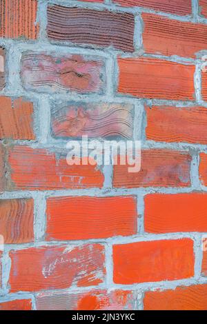 Bricks with lines and cement grout- San Francisco, California. Close-up of a lined red and brown bricks on a wall with running bond pattern. Stock Photo