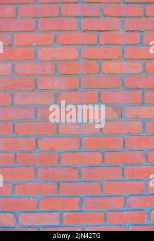 Red bricks close-up with running bond pattern in San Francisco, California. Close-up of a brick wall exterior stacked with cement. Stock Photo