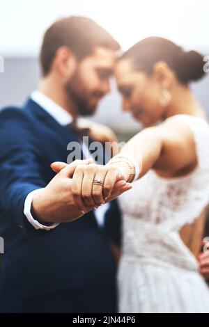 Im dancing into forever with you. a happy newlywed young couple holding hands and dancing together on their wedding day. Stock Photo