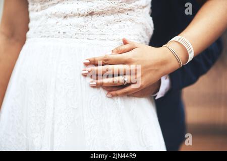 Ill always hold you dear my love. an unrecognizable newlywed couple holding hands on their wedding day. Stock Photo