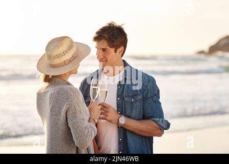 Summer is considered the most romantic season. a middle aged couple having champagne while spending the day outdoors. Stock Photo
