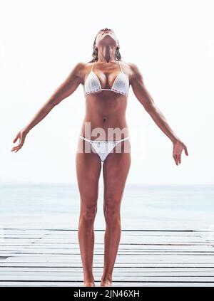 Showing off her bikini body. a beautiful young woman at the beach Stock  Photo - Alamy