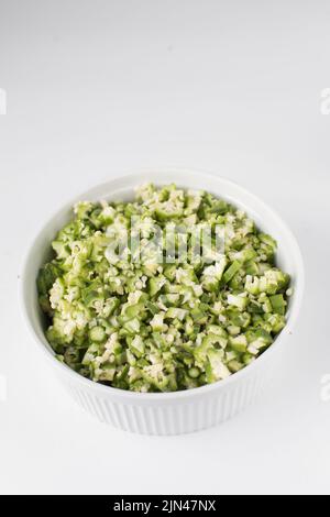Chopped okra in a white ramekin, chopped lady fingers Stock Photo