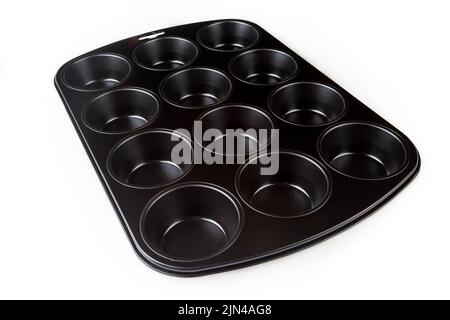 Muffin cake pan with non-stick coating isolated on a white background. 12-cup muffin baking tray. Empty cupcake bake ware for pie, tart, cake and past Stock Photo