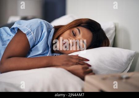 Sleeping in. an attractive young woman sleeping peacefully in bed at home. Stock Photo