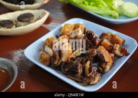 Thai style BBQ Roasted pork in blue dish for lunch Stock Photo