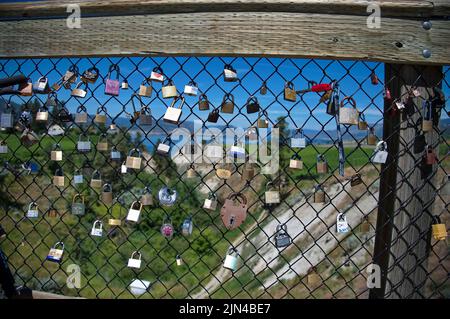 Love locks hanging on the fence of the bridge Stock Photo