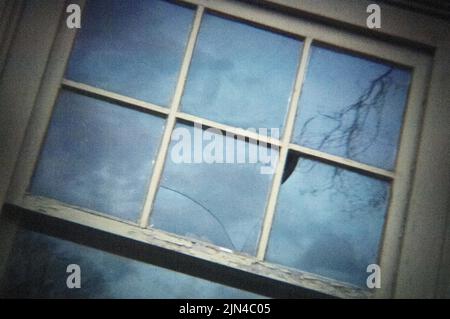 Broken Window on Old Garage Stock Photo