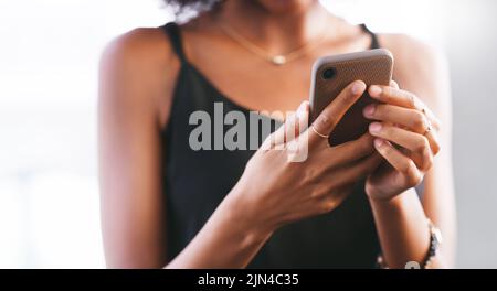 The world is growing increasingly smartphone fluent. a woman using a smartphone. Stock Photo