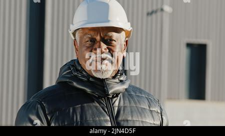 Portrait of elderly african american confident man professional engineer construction worker in safety helmet successful builder contractor foreman Stock Photo