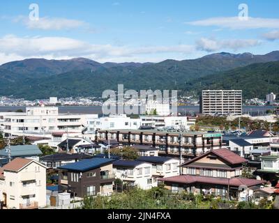 Suwa, Japan - October 22, 2017: View of Kamisuwa onsen, a hot spring resort on the shores of Lake Suwako, from the top of Takashima castle Stock Photo