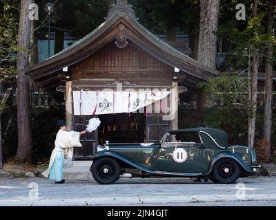 Chino, Nagano Prefecture, Japan - October 22, 2017: Shinto priest blessing a car at Suwa Taisha Kamisha Honmiya during The Peninsula Tokyo Rally Nippo Stock Photo