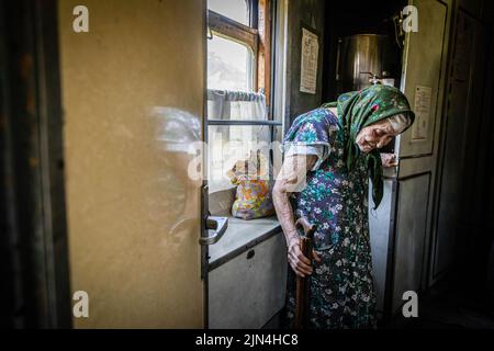 An old lady can be seen on the evacuation train to Dnipro. Amid the intensified fighting in the Eastern part of Ukraine, east Ukraine is now intensifying its civilian evacuation, as millions of Ukrainian families have been evacuating from the closer and closer war, as many of them will be relocated to the western part of the country. According to the United Nations, at least 12 million people have fled their homes since Russia's invasion of Ukraine, while seven million people are displaced inside the country. Stock Photo