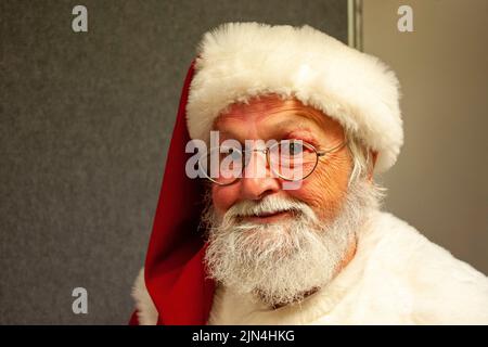 A department store Santa behind the scenes at a shopping centre in Hobart, Tasmania, Australia during the pre-Christmas shopping period Stock Photo