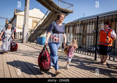 August 6, 2022, Donetsk Oblast, Donets'ka Oblast'', Ukraine: A mother is seen boarding the evacuation train with her daughter at the Pokrovsk Train Station. Amid the intensified fighting in the Eastern part of Ukraine, east Ukraine is now intensifying its civilian evacuation, as millions of Ukrainian families have been evacuating from the closer and closer war, as many of them will be relocated to the western part of the country.According to the United Nations, at least 12 million people have fled their homes since Russia's invasion of Ukraine, while seven million people are displaced insid Stock Photo