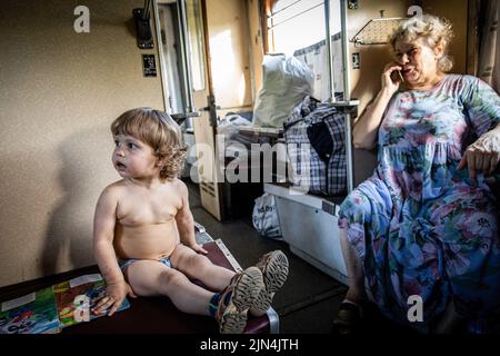 August 6, 2022, Donetsk Oblast, Donets'ka Oblast'', Ukraine: A child and his grandmother are seen on the evacuation train to Dnipro. Amid the intensified fighting in the Eastern part of Ukraine, east Ukraine is now intensifying its civilian evacuation, as millions of Ukrainian families have been evacuating from the closer and closer war, as many of them will be relocated to the western part of the country.According to the United Nations, at least 12 million people have fled their homes since Russia's invasion of Ukraine, while seven million people are displaced inside the country. (Credit I Stock Photo