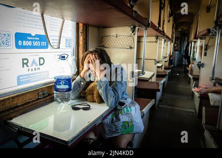 August 6, 2022, Donetsk Oblast, Donets'ka Oblast'', Ukraine: A young girl cries as the evacuation train departs for Dnipro at the Pokrovsk Train Station. Amid the intensified fighting in the Eastern part of Ukraine, east Ukraine is now intensifying its civilian evacuation, as millions of Ukrainian families have been evacuating from the closer and closer war, as many of them will be relocated to the western part of the country.According to the United Nations, at least 12 million people have fled their homes since Russia's invasion of Ukraine, while seven million people are displaced inside t Stock Photo