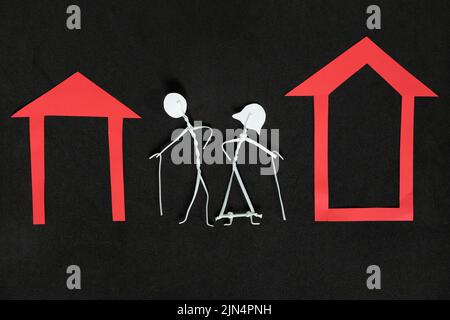 Homeless seniors, retirement home or abandoned old people concept. Elderly couple stick figure in dark black background creative composition. Stock Photo