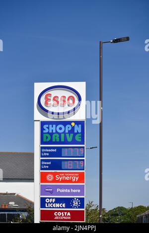 Esso petrol station sign in Portsmouth showing current UK fuel prices and other services. August 2022 Stock Photo