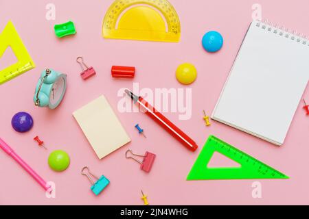 Supplies creative tools for school creative work on pink background with pattern stationery, colored paints brushes pencils, pens notepad on a spiral copy space, flat set, mock up Stock Photo