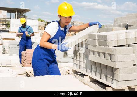 Man and woman working in construction material storage Stock Photo
