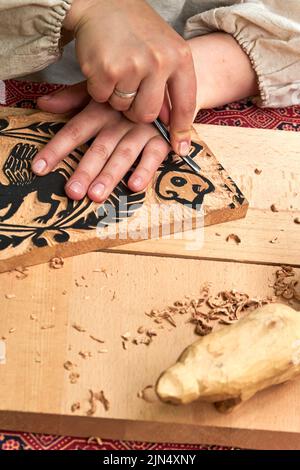 Wooden stamps for medieval ink printing on fabric and vintage clothing. Reconstruction of the events of the Middle Ages in Europe. Stock Photo