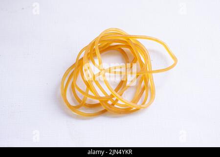 Close up of different colored rubber bands isolated on a black background  Stock Photo by wirestock