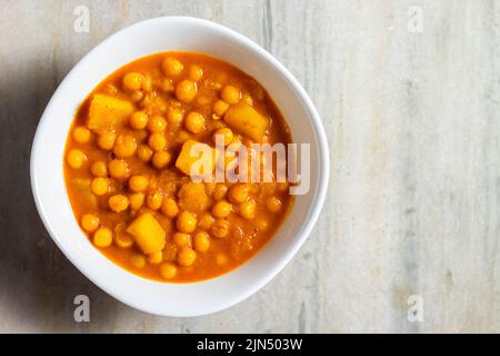 selective focus of delicious Bengali street food 'Ghugni' made of chickpeas. with a marble background. Stock Photo