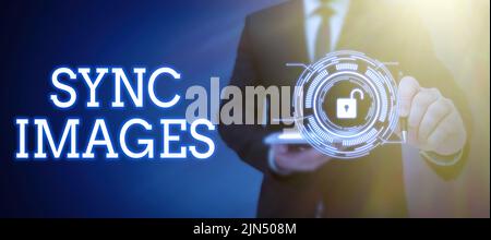 Conceptual caption Sync Images. Conceptual photo Making photos identical in all devices Accessible anywhere Businessman in suit holding open palm Stock Photo